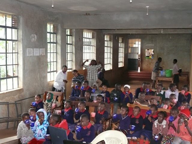 children in a school auditorium in Kenya Africa children in a school auditorium in Kenya Africa