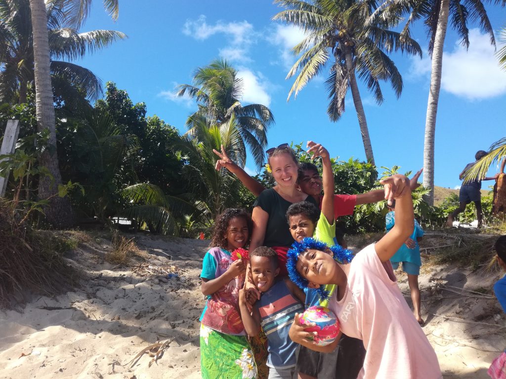 Noora on the beach in Fiji with the children 1024x768 - Group Volunteering