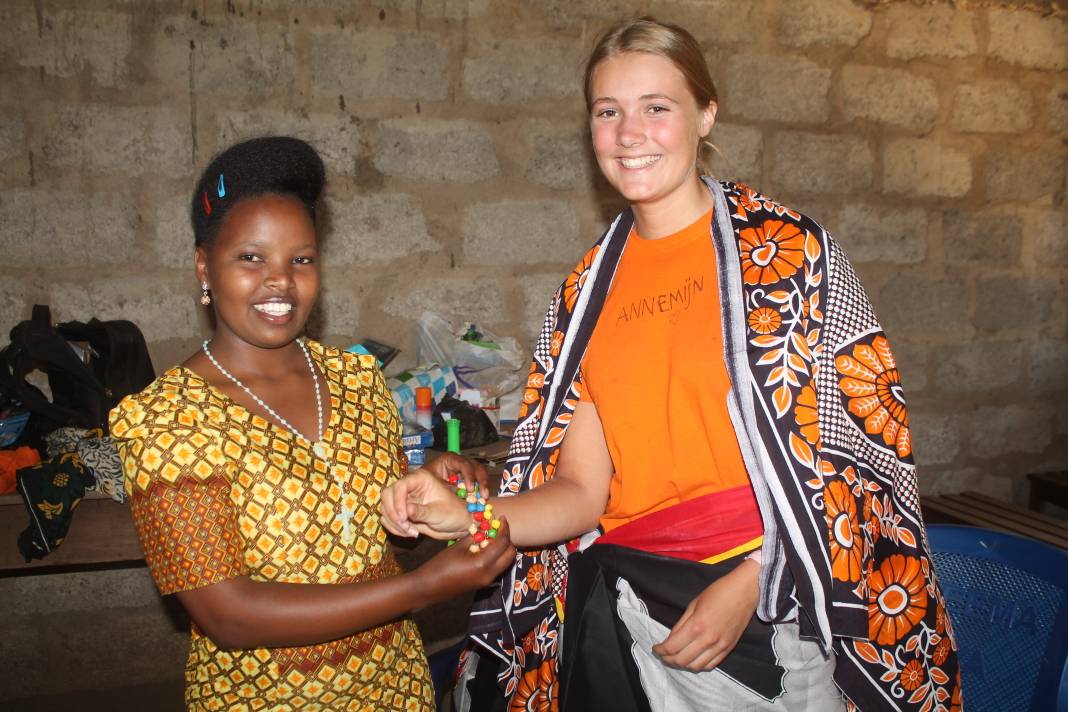 Participant receiving a gift from a teacher - 6 Reasons Why Volunteering in Tanzania Should Be Your Next Trip