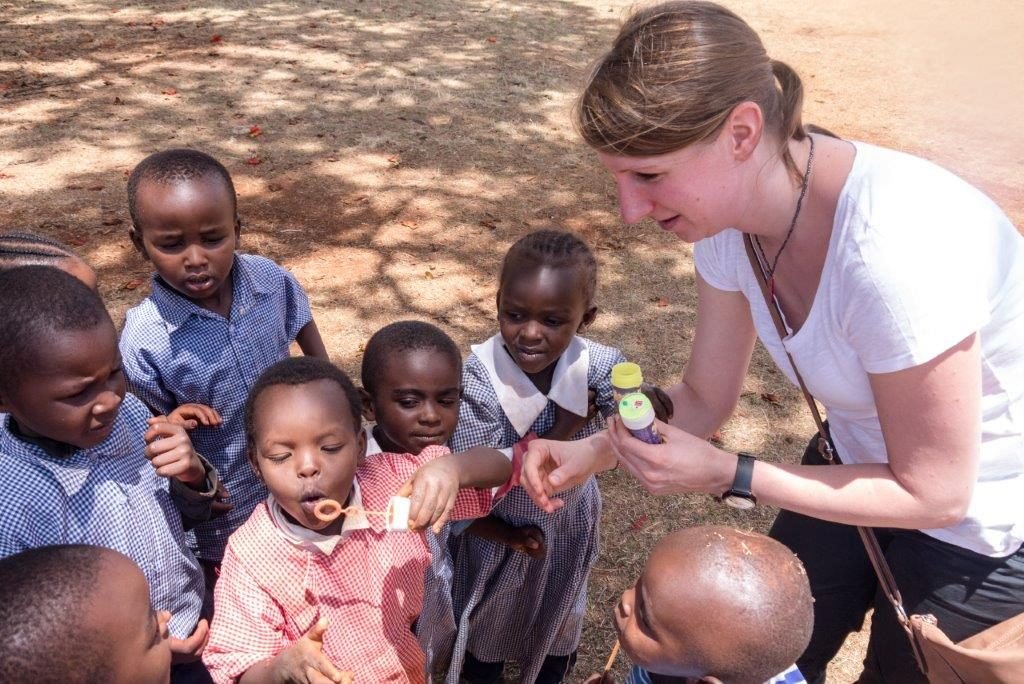 Kenya2 SS Participant and students blowing bubbles 1024x684 - Kenya2 SS