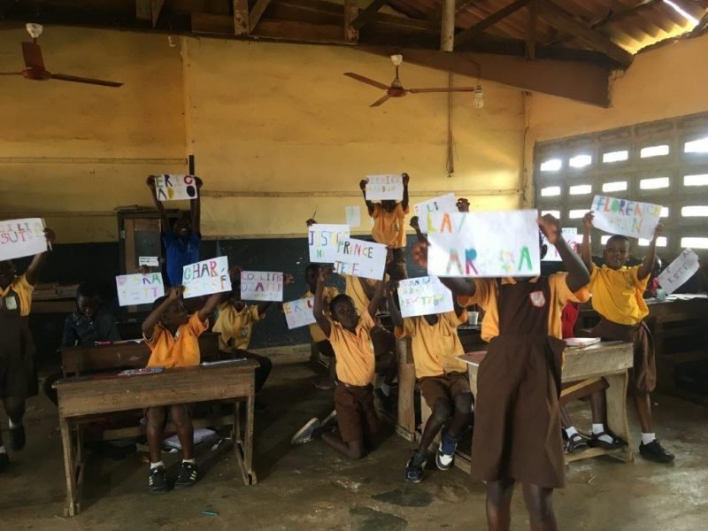 children holding up their art work children holding up their art work