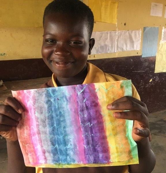 child holding up his painting child holding up his painting