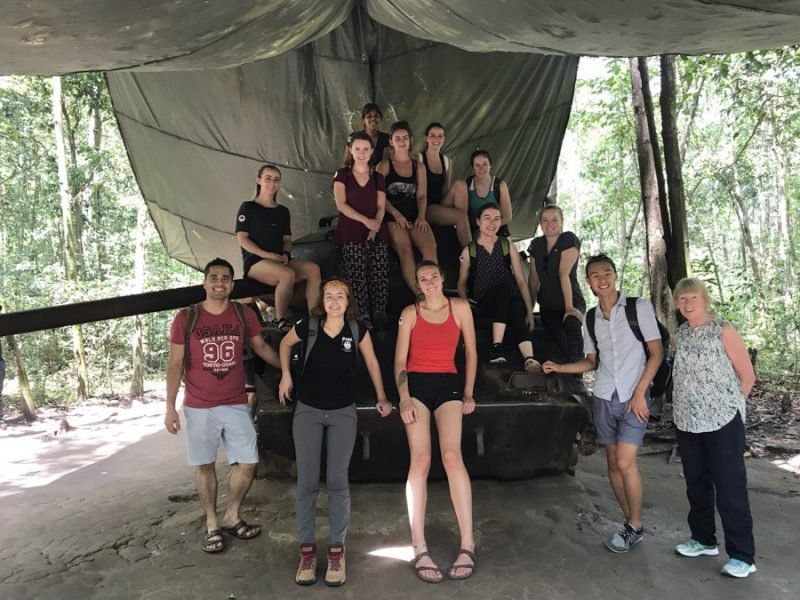 Cu Chi Tunnels - Group photo on top of a war tank (1) Cu Chi Tunnels - Group photo on top of a war tank (1)