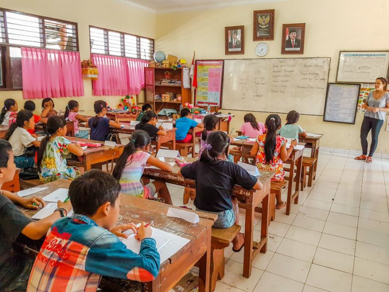 children at classroom desks working 800x600 - Volunteer Teaching Bali