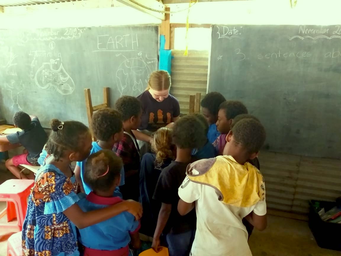 teacher checking students work - Vanuatu Review of Primary Teaching