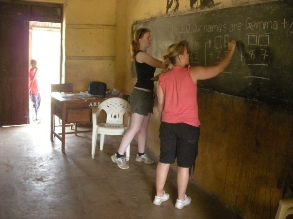 Participants writing on a chalkboard - Quick Tips for Packing for Your Volunteer Trip