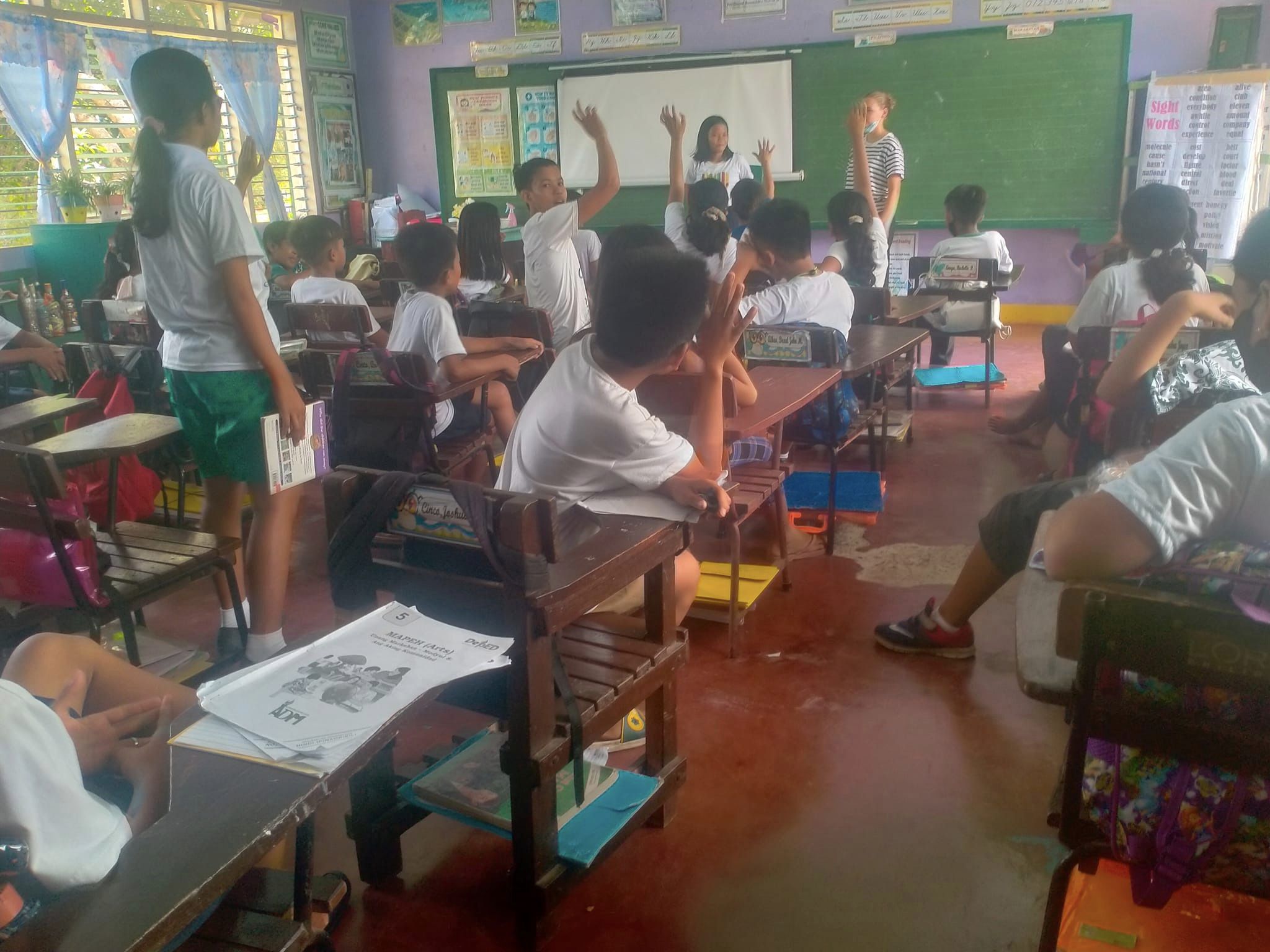 kids raising hands in class - Primary English Teaching