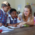 with students at desk 150x150 - Volunteering Overseas Broke My Heart. Here’s Why I’d Do It Again