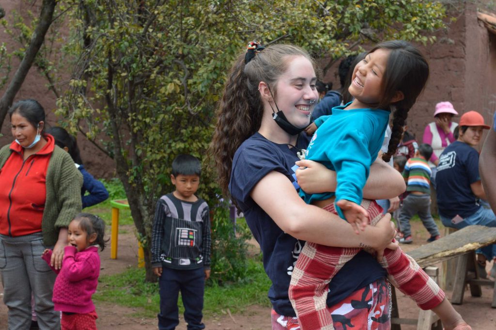 volunteer holding child in peru 4 1024x681 - Adventure Weeks