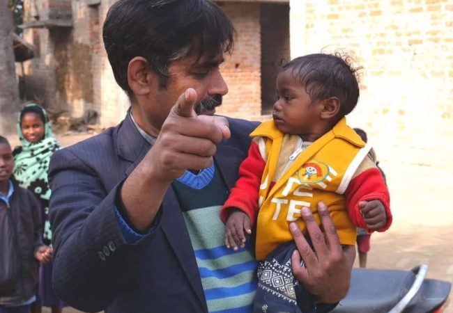 Bodhgaya director holding small child
