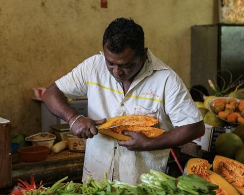 man cutting fruit man cutting fruit