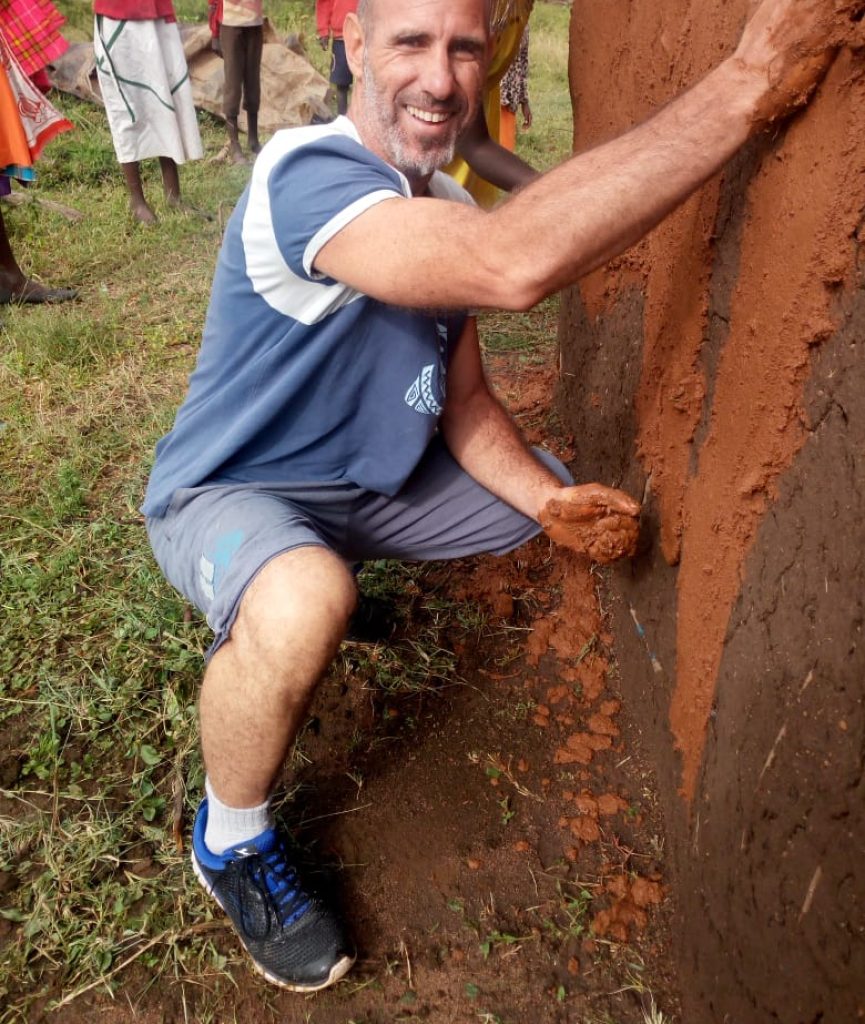 Participant helping maasai people building a new house for bride