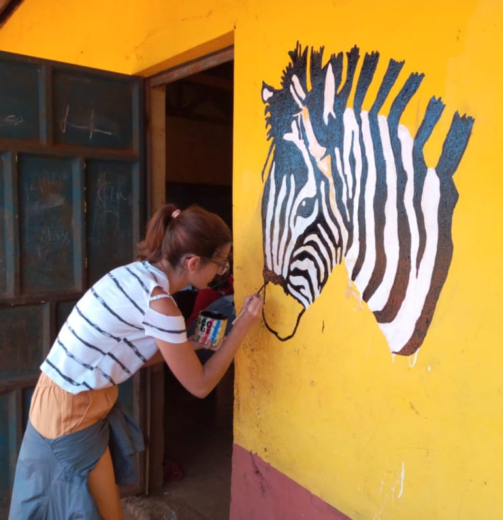 Participant painting the local school