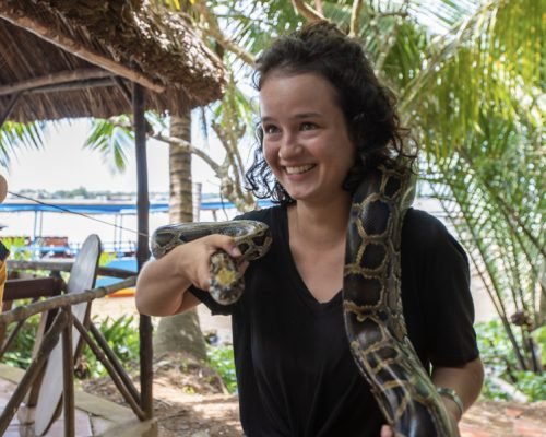 Tourist holding the pyton