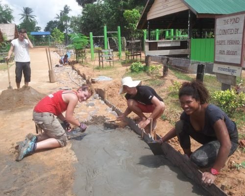 volunteers laying the path outside rural school cambodia volunteers laying the path outside rural school cambodia