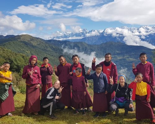 group of monks with mountain backdrop