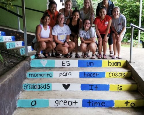 Community Construction Costa Rica group stand by art work on steps omz233iwljjfl8cj66c4fc11h8i1qurab7x1cekkv4 - Community Construction Costa Rica