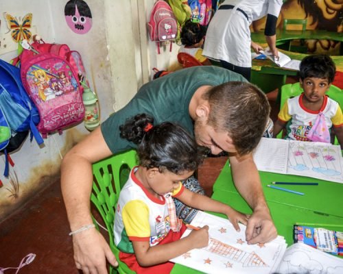 helping kindergarten child at table helping kindergarten child at table