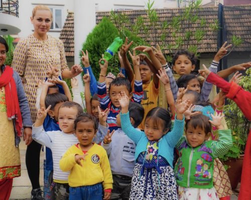 Kindergarten Volunteering Kathmandu, Nepal kindergarten children with hands in air ojakygt8qyqwinnw6tjoed1axnwr2qslbe8d9n0kv4 - Kindergarten Volunteering Kathmandu, Nepal