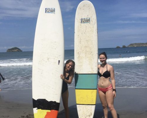 standing with surfboards